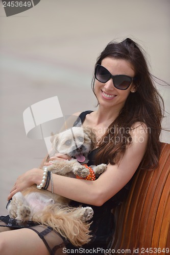 Image of happy young woman with puppy have fun