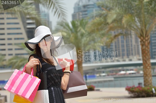 Image of beautiful woman goes in shopping