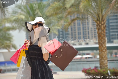 Image of beautiful woman goes in shopping