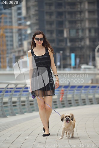 Image of happy young woman with puppy have fun