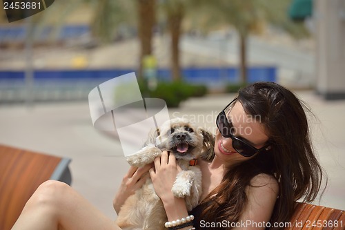 Image of happy young woman with puppy have fun