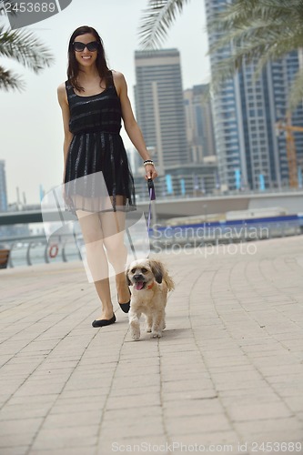 Image of happy young woman with puppy have fun