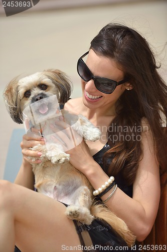 Image of happy young woman with puppy have fun