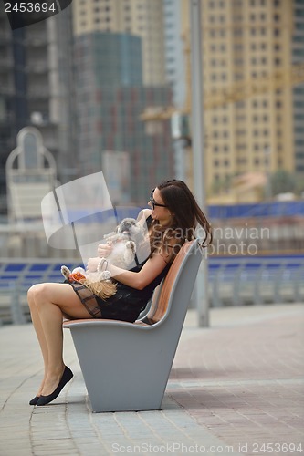 Image of happy young woman with puppy have fun