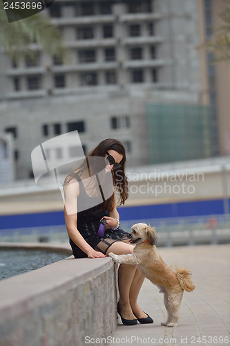 Image of happy young woman with puppy have fun