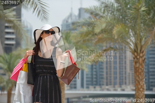 Image of beautiful woman goes in shopping