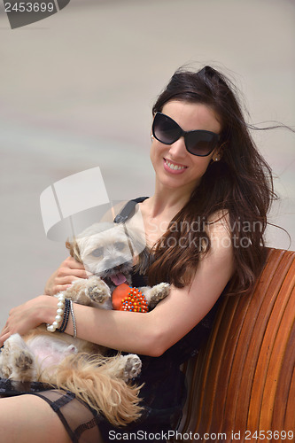 Image of happy young woman with puppy have fun