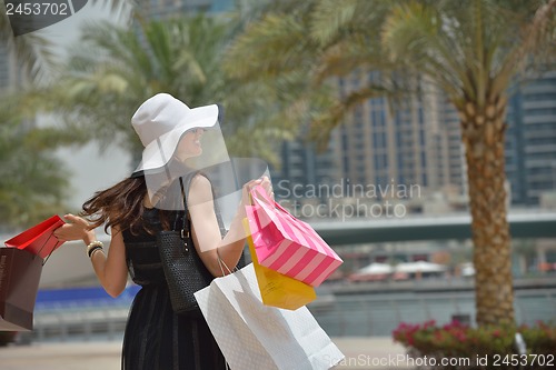 Image of beautiful woman goes in shopping