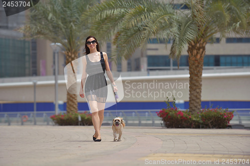 Image of happy young woman with puppy have fun