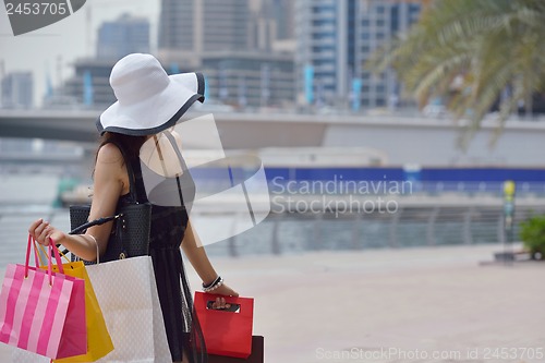 Image of beautiful woman goes in shopping