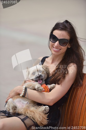 Image of happy young woman with puppy have fun