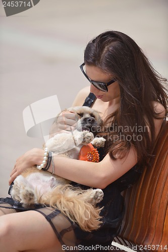 Image of happy young woman with puppy have fun