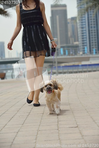 Image of happy young woman with puppy have fun