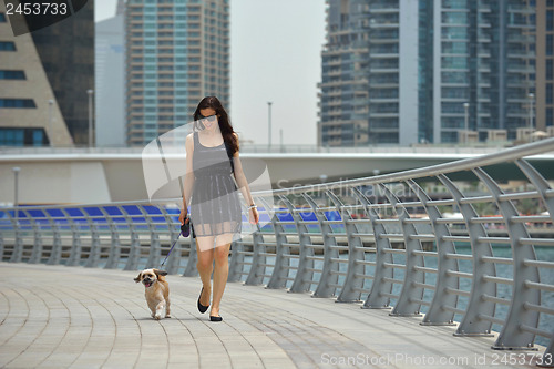 Image of happy young woman with puppy have fun