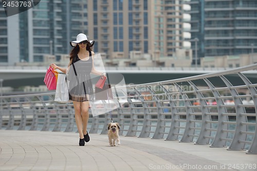 Image of beautiful woman goes in shopping