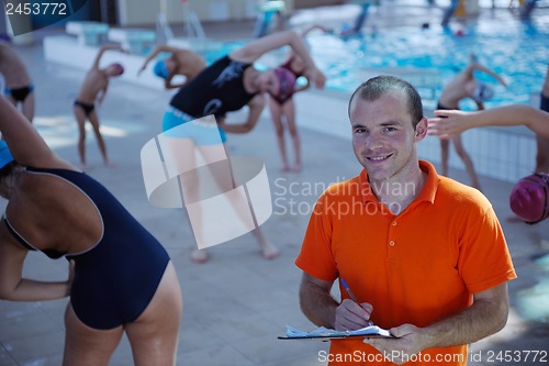 Image of happy children group  at swimming pool