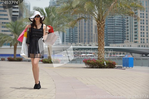 Image of beautiful woman goes in shopping