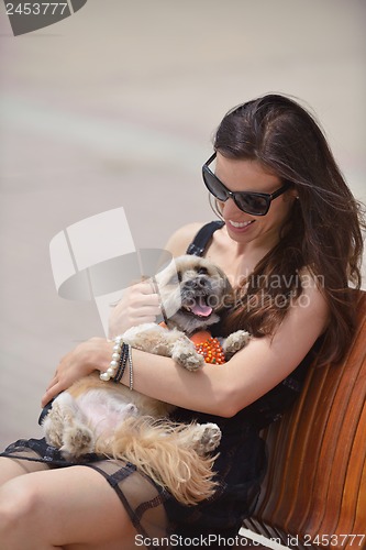 Image of happy young woman with puppy have fun