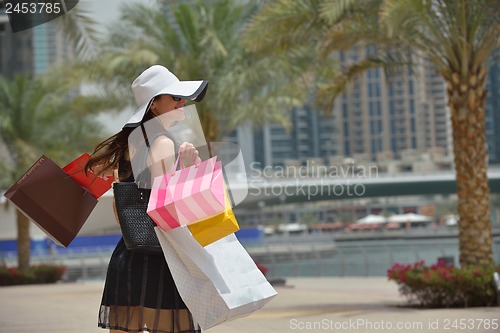 Image of beautiful woman goes in shopping