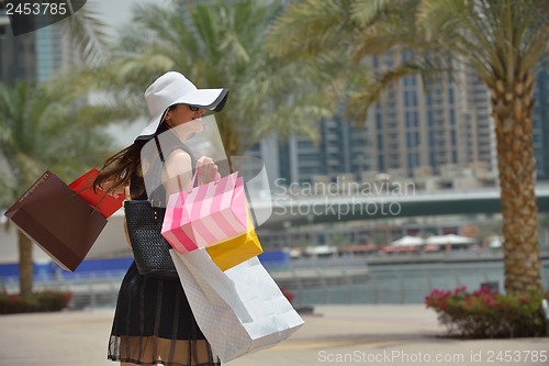 Image of beautiful woman goes in shopping