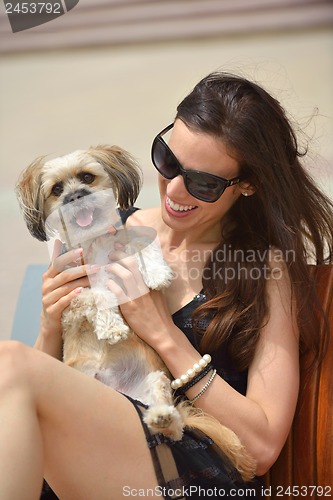 Image of happy young woman with puppy have fun