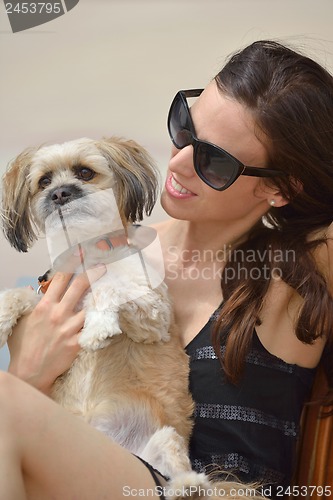 Image of happy young woman with puppy have fun