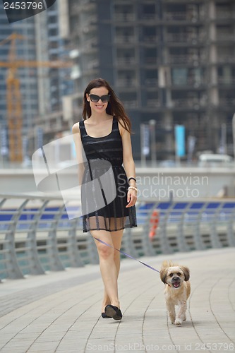 Image of happy young woman with puppy have fun