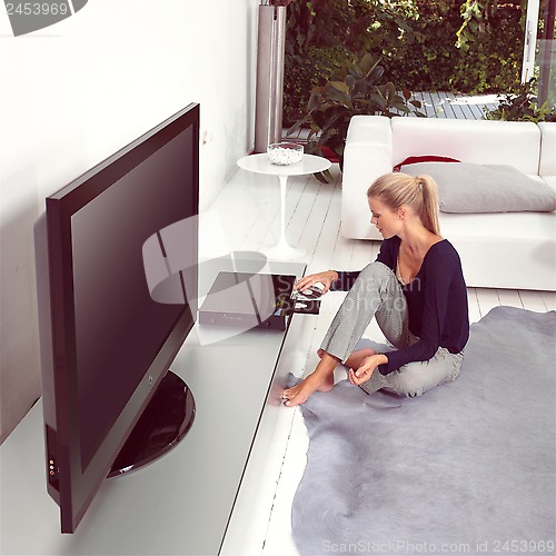 Image of woman using dvd player