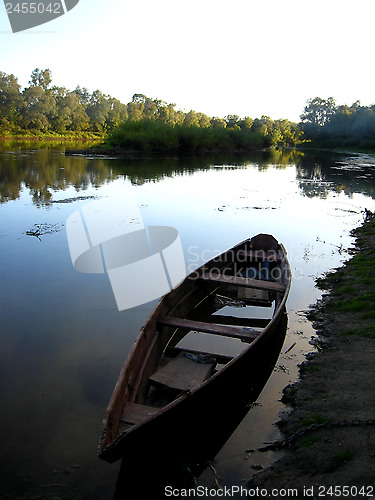 Image of landscape with river and boat in the evening