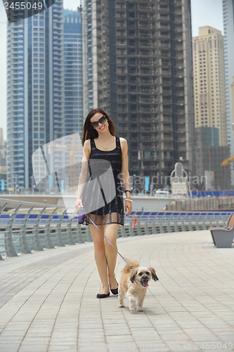 Image of happy young woman with puppy have fun