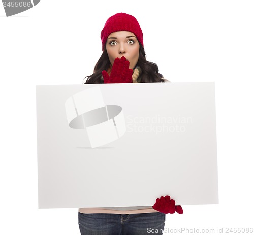 Image of Stunned Girl Wearing Winter Hat and Gloves Holds Blank Sign 