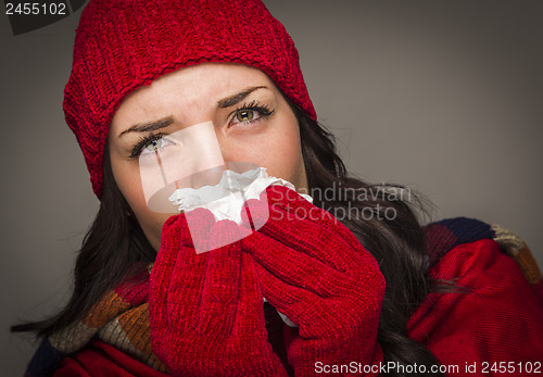 Image of Sick Mixed Race Woman Blowing Her Sore Nose With Tissue
