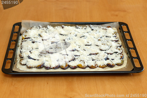 Image of plum cake in plate prepared for baking