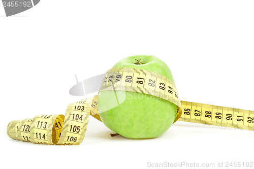 Image of Green apple and measuring tape isolated on white background
