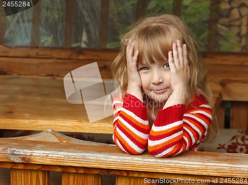 Image of Little girl in wooden canopy outdoor