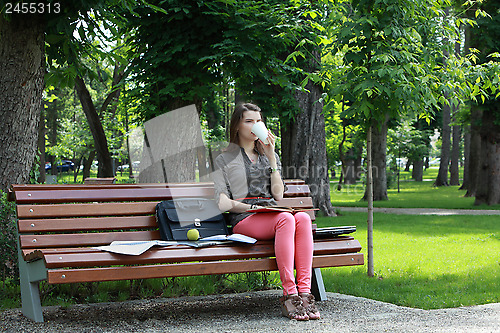 Image of Young Woman Drinking Coffee