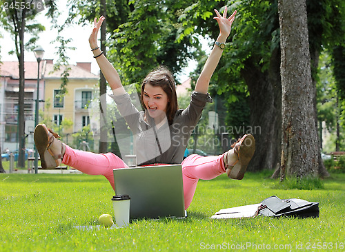 Image of Happy Woman with Computer in an Urban Park