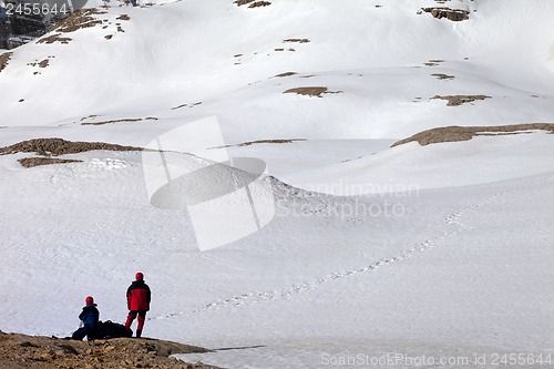 Image of Two hikers on halt in snowy mountain