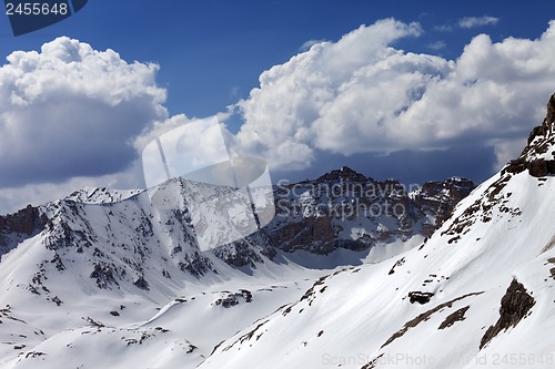 Image of Snowy mountains and blue sky with cloud in sunny spring day