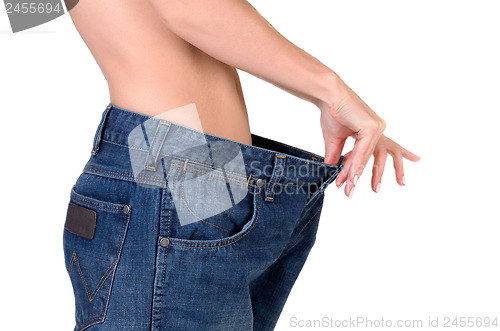 Image of slim girl in big jeans