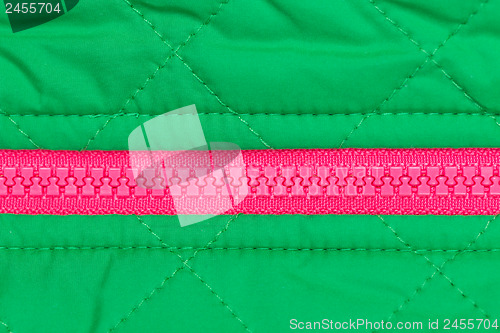 Image of pink zipper on the green fabric