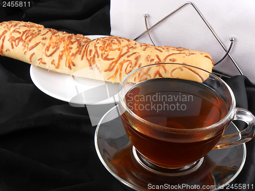 Image of Hot tea with bread on black background