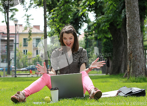 Image of Happy Young Woman on a Laptop