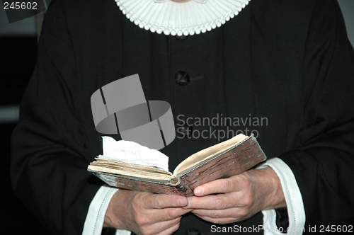 Image of Priest and bible