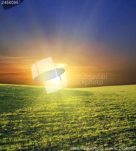 Image of sunset over green field