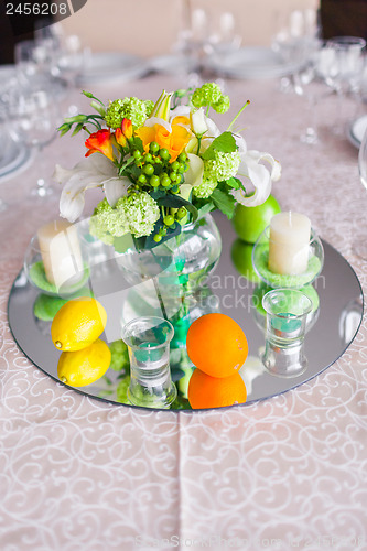 Image of tables decorated with flowers and fruit