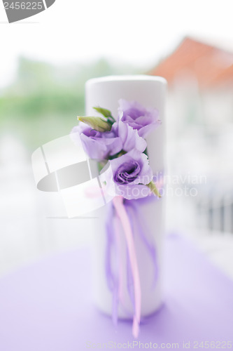 Image of candle decorated with flowers