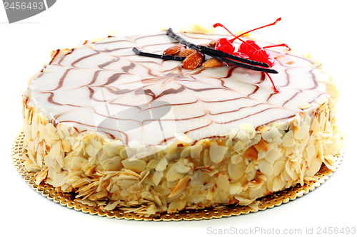 Image of Esterhazy cake decorated with cherries and almonds.