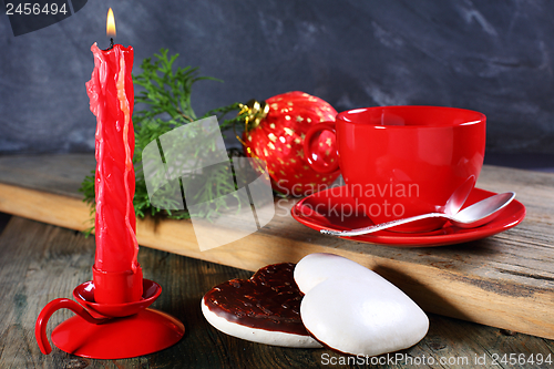 Image of Gingerbread, candle and Christmas ball.