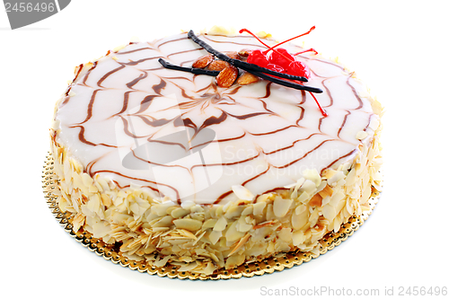 Image of Esterhazy almond cake with red cherries. 